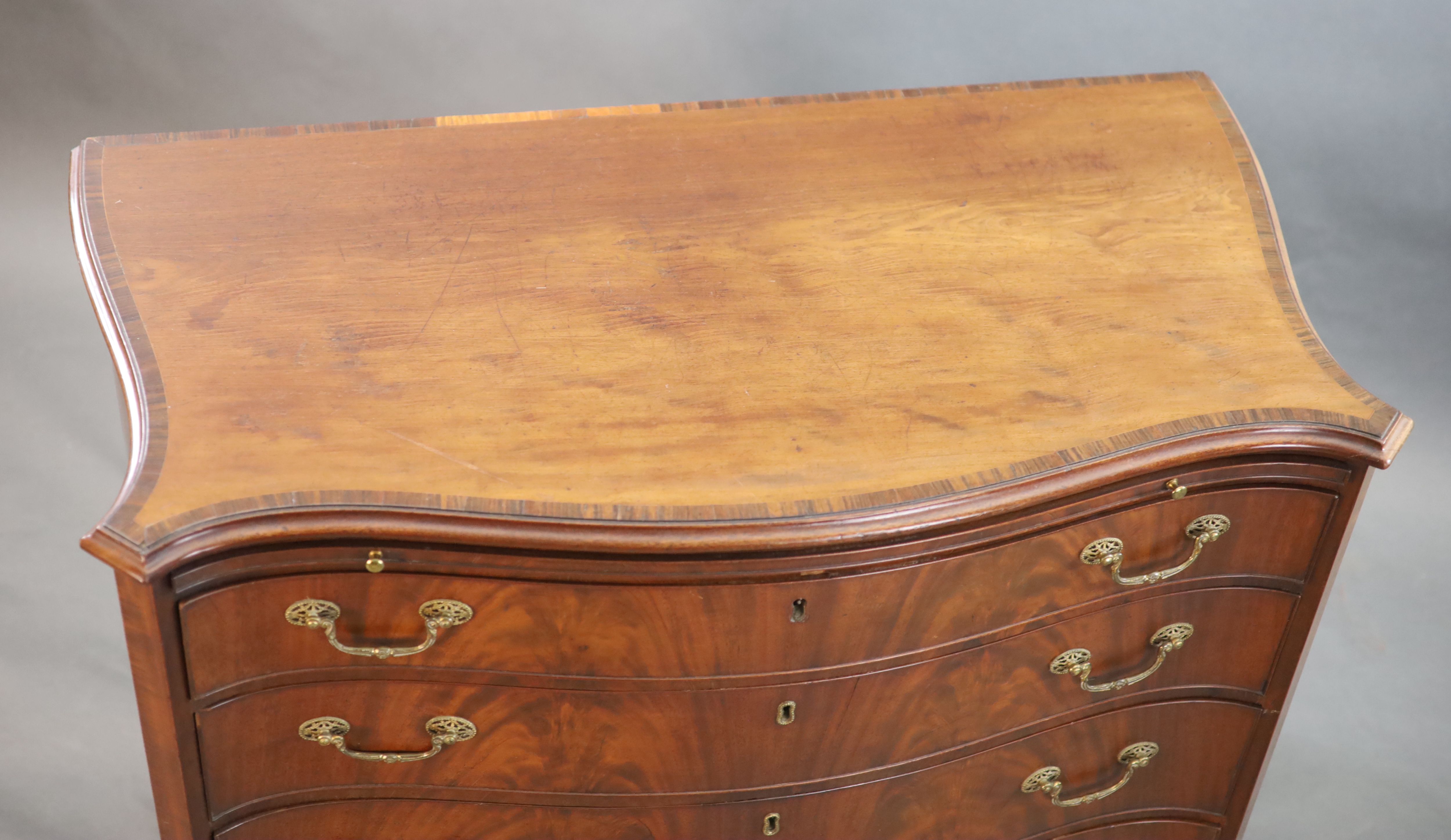 A George III mahogany and rosewood banded serpentine fronted chest, W. 3ft 7in. D. 1ft 10in. H. 2ft 11in.